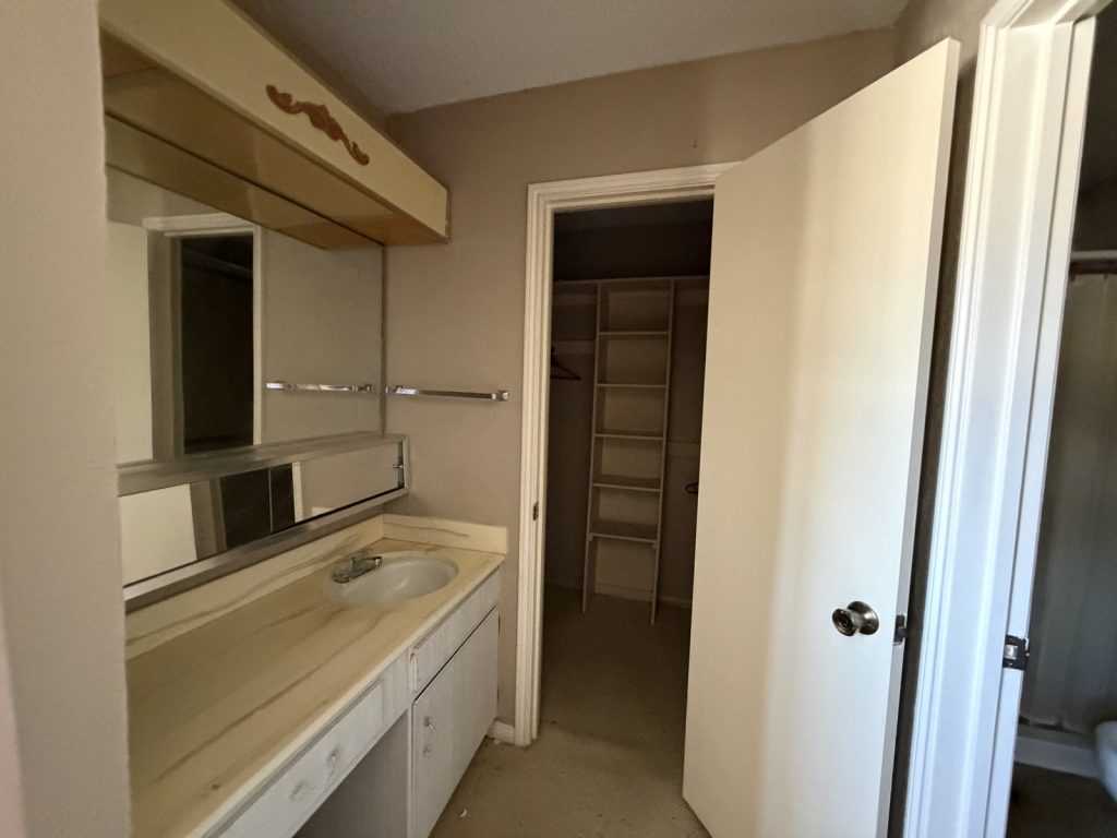Dated bathroom and closet in an inherited west Houston TX house sold for cash