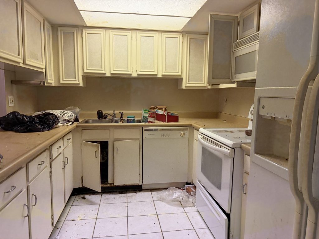 Deteriorated kitchen in an abandoned Houston TX house purchased as-is by cash home buyers