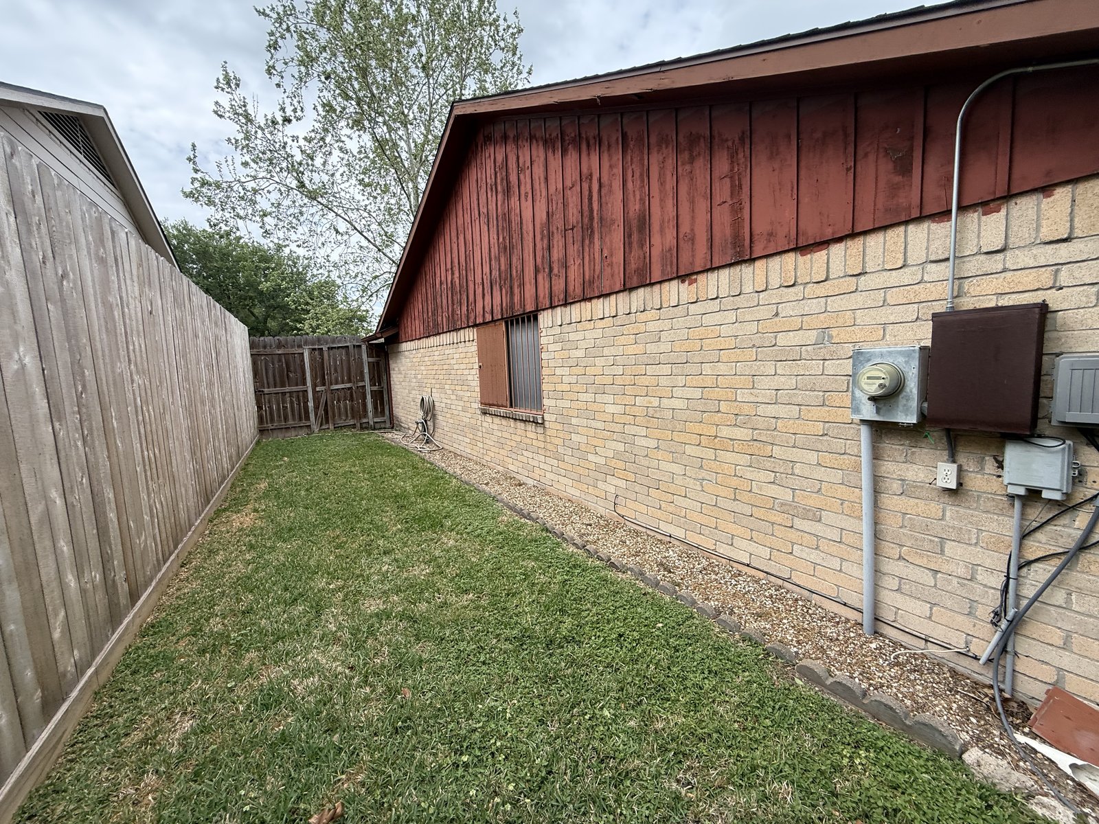 Side exterior of well-kept brick home bought for cash in Mission Bend, Houston TX