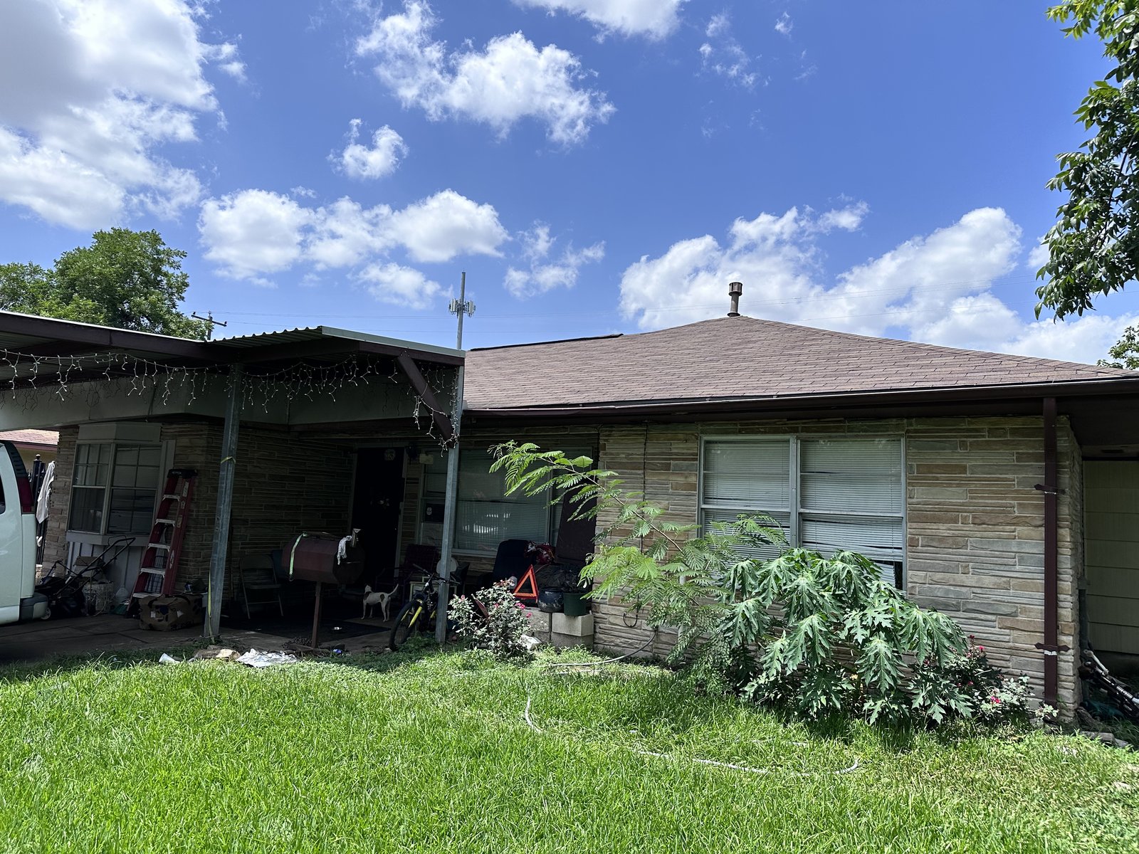 Front view of a 1950s stone ranch home bought for cash in Spring Branch, Houston TX