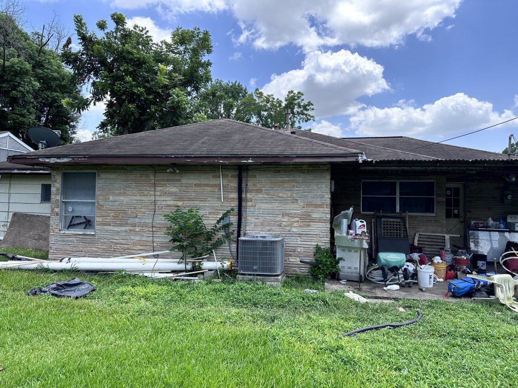 Rear exterior of an outdated Houston TX house purchased as-is by cash home buyers