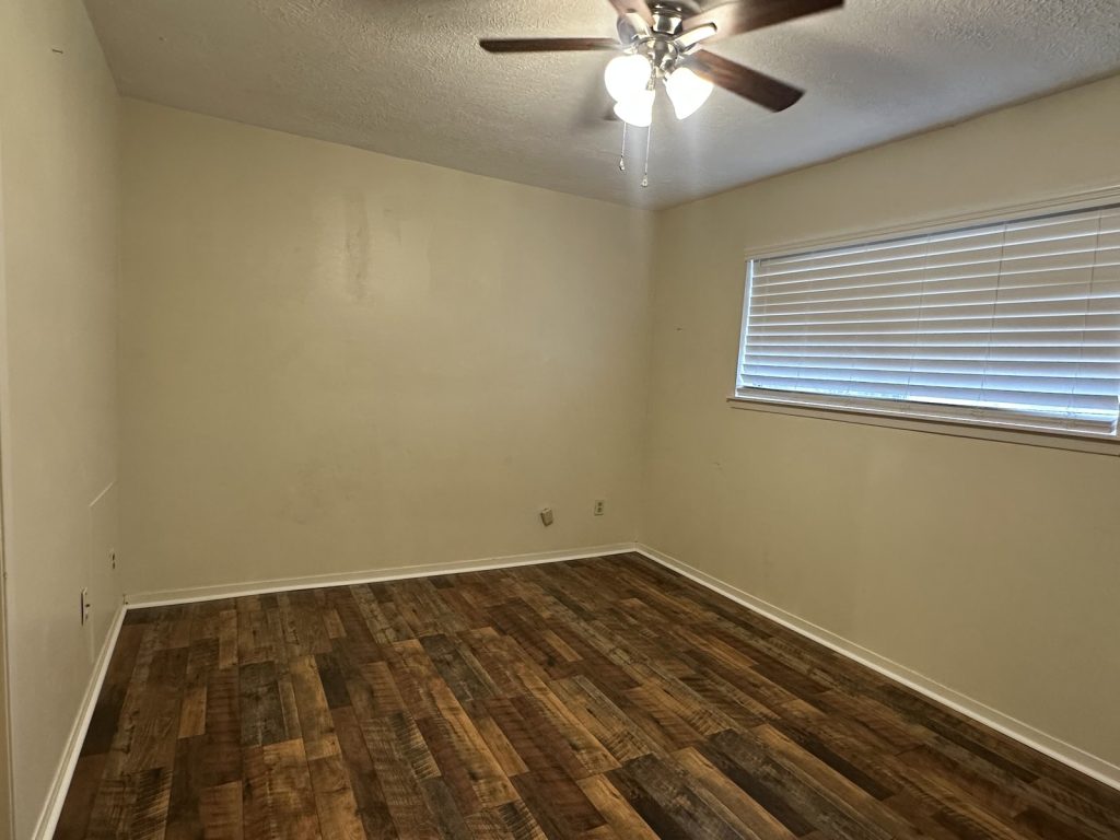 Bedroom in a Garden Walk rental townhome in La Porte, TX sold as-is