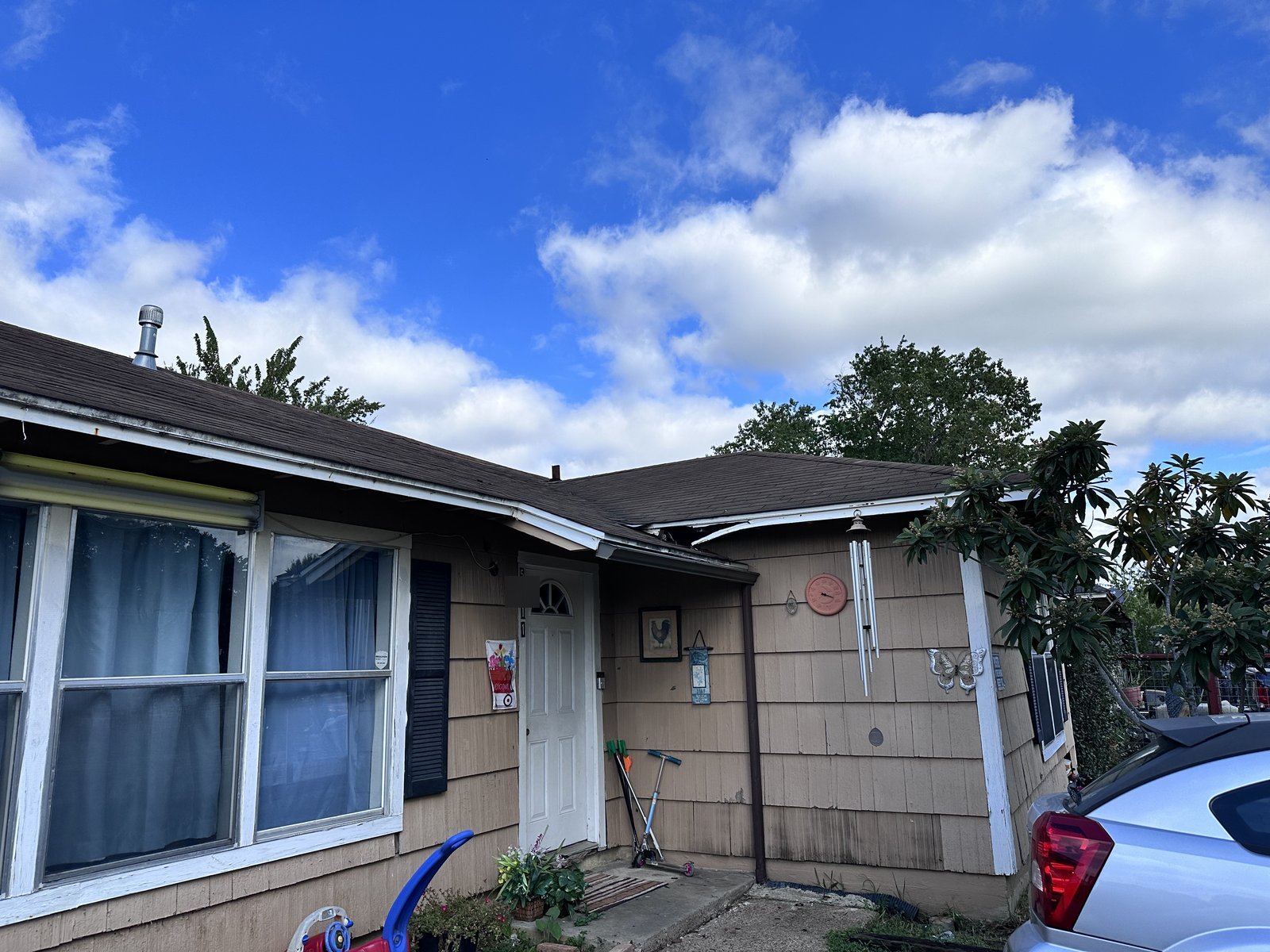 Front of occupied shingle-sided home bought for cash in Southcrest, Houston TX