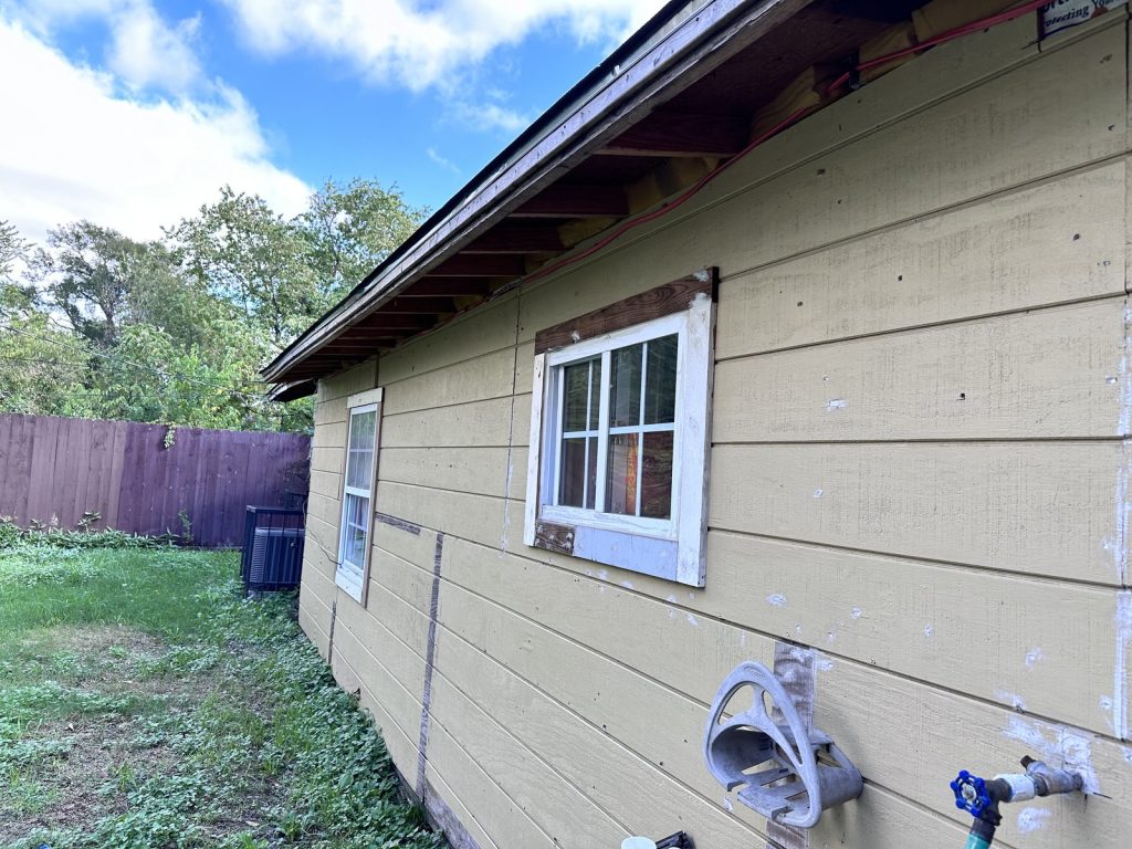 Unfinished siding and window trim repairs on Houston TX home sold as-is