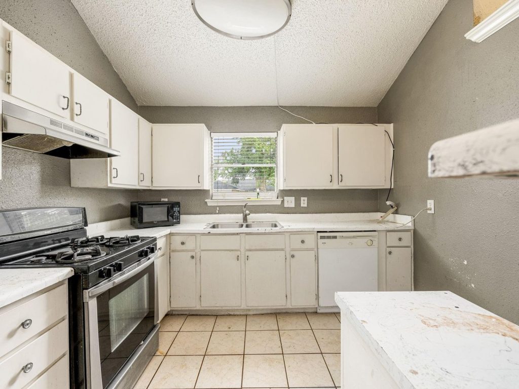 Dated kitchen in a Paddock, Cypress TX rental sold as-is