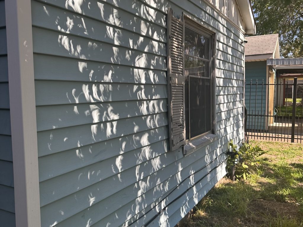Exterior siding and windows of a tenant-occupied rental sold for cash in Woodland Acres, North Shore, TX