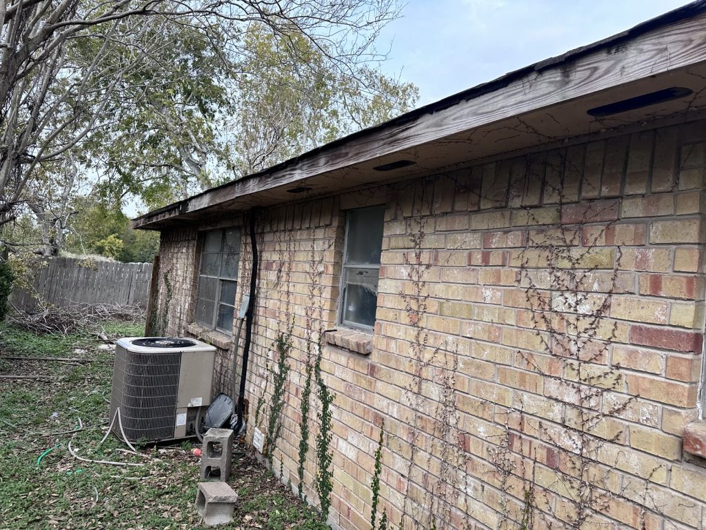 AC unit and side wall of a Twining Oaks Lane home in Missouri City, TX showing water damage