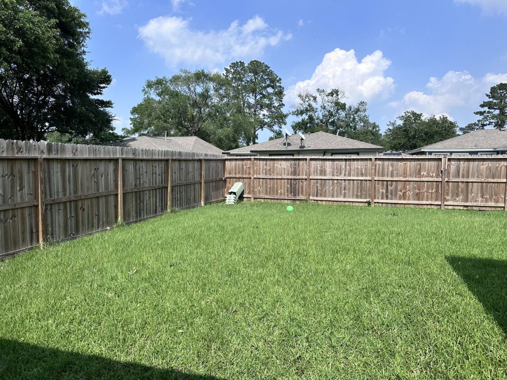Backyard of a fire-damaged home sold before foreclosure in Parkwood East, Houston, TX