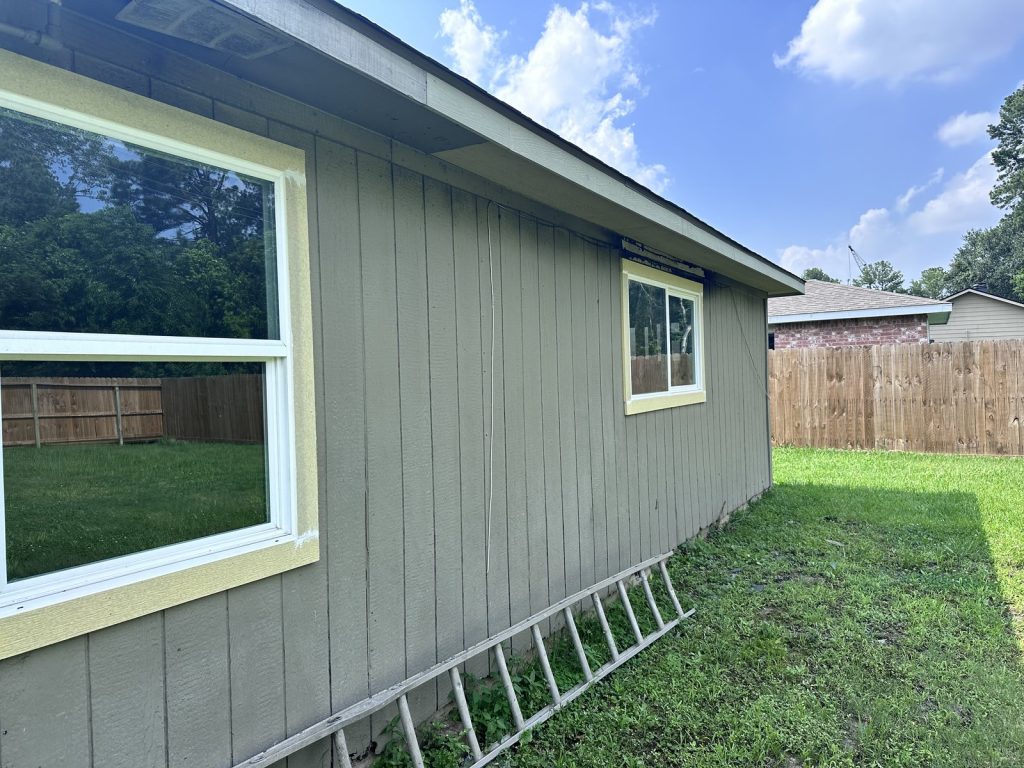 Side exterior of a fire and flood-damaged home sold for cash in Parkwood East, Houston, TX
