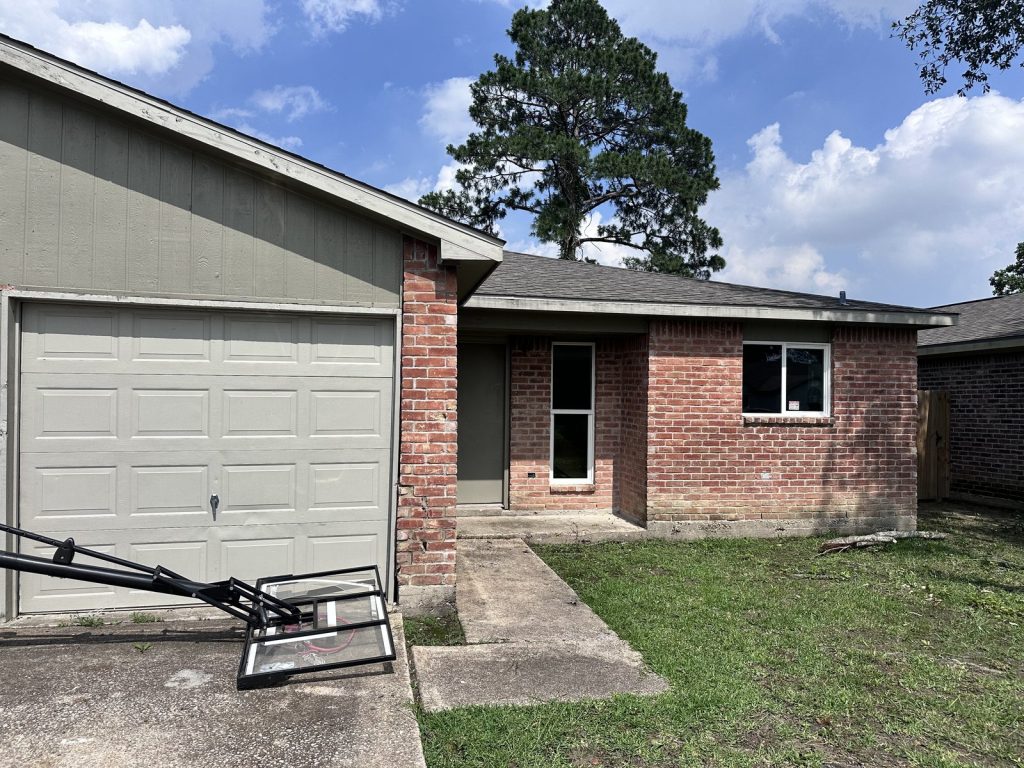Side entry brick exterior of a fire-damaged property in Parkwood East, Houston, TX