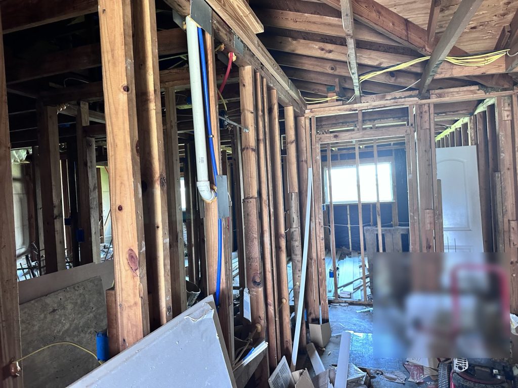 Gutted framing of a fire-damaged rental purchased for cash in Parkwood East, Houston, TX