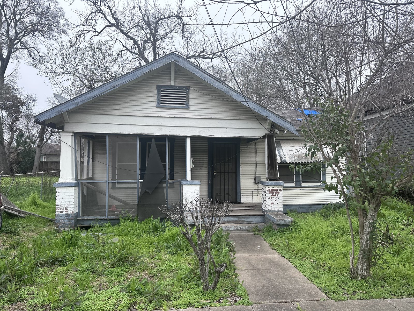 Front of vacant wood-frame bungalow bought for cash in Clute TX