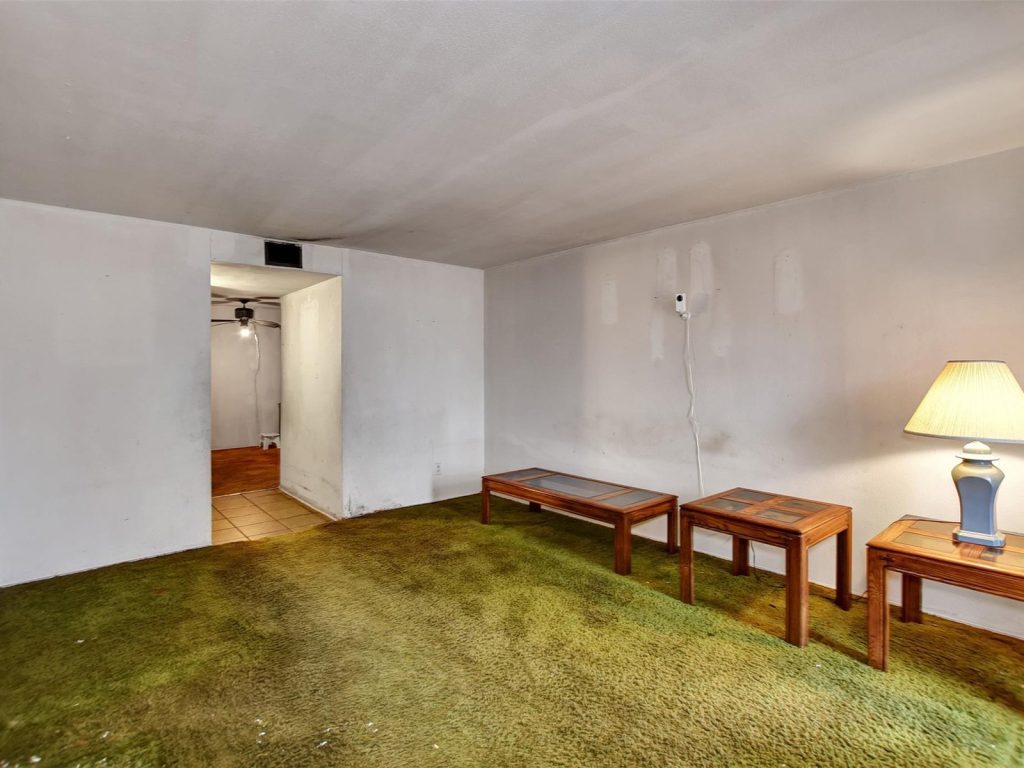 Living room with original shag carpet in as-is Houston TX home purchased for cash
