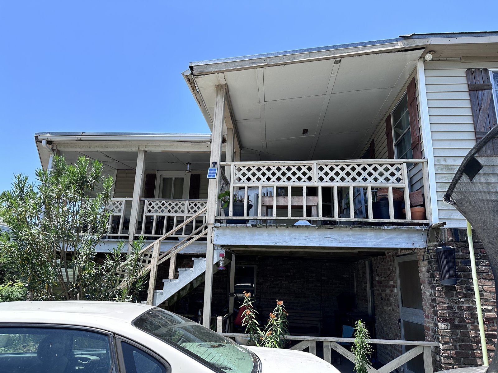 Raised two-storey home on brick piers bought for cash as-is on the West End of Galveston, TX