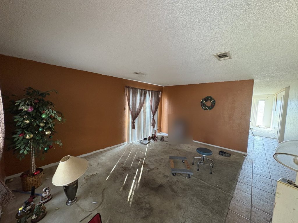 Living room left furnished in abandoned Houston TX home bought by cash home buyers