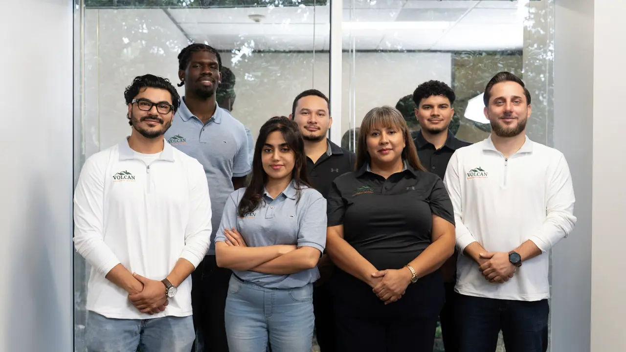 The Volcan Property Buyers team standing together at the company office