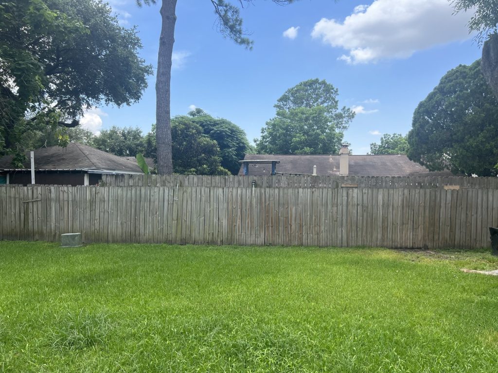 Fenced back yard of Northwest Park Houston TX house sold by a retiring landlord